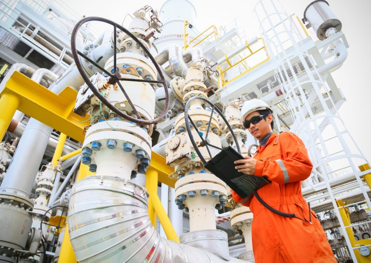 operator recording operation of oil and gas process at oil and rig plant, offshore oil and gas industry, offshore oil and rig in the sea, operator monitor production process, routine daily record.