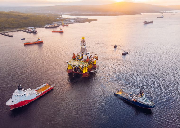 Ships are transporting offshore oil rig for installation sea for repairs, aerial top view.